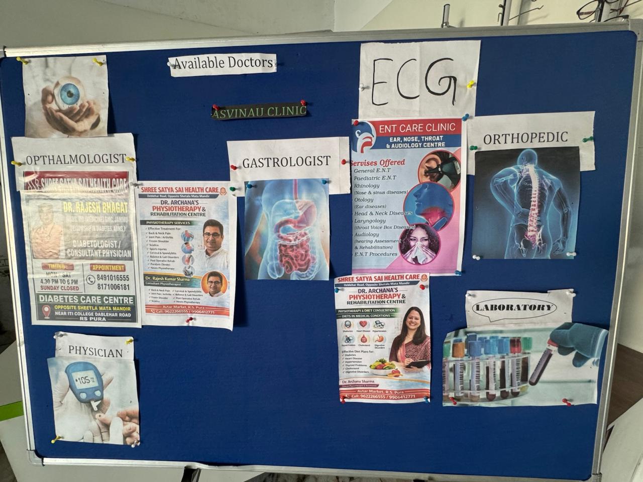 The 'Available Doctors' notice board at the clinic listing ophthalmologist, physician, gastrologist, ENT, orthopedic, ECG, laboratory and physiotherapy services